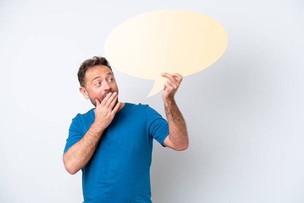 Middle age caucasian man isolated on white background holding an empty speech bubble with surprised expression - Φωτογραφία, εικόνα