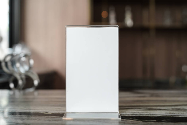 blank for text marketing promotion. Mock up Menu frame standing on wood table in restaurant space for text. - 写真・画像