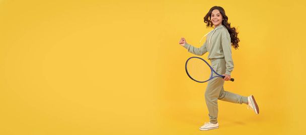 happy energetic kid jump in sportswear with tennis racket running to success, active childhood. Horizontal poster of isolated child face, banner header, copy space - Zdjęcie, obraz