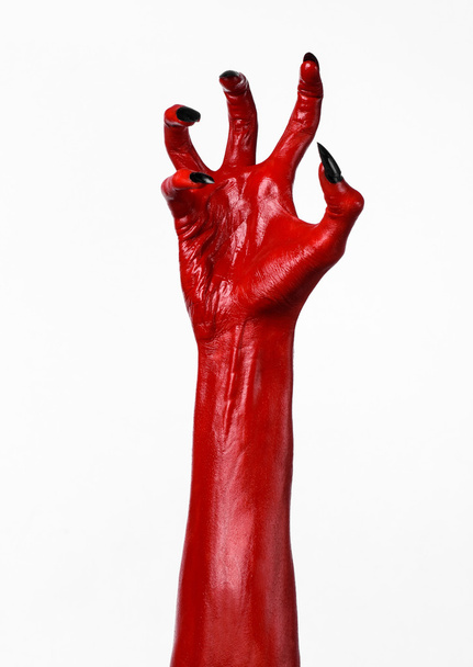 Red Devil's hands, red hands of Satan, Halloween theme, white background, isolated - 写真・画像