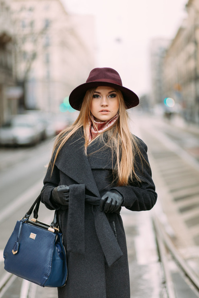 Young beautiful woman in hat in the city street - Фото, зображення