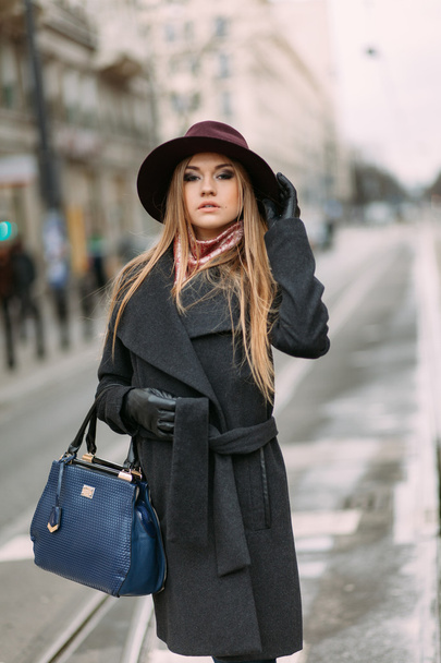 Young beautiful woman in hat in the city street - Фото, изображение
