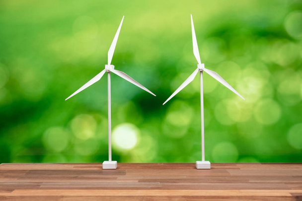 Windmill or wind turbine farm model on office table design symbolizing modern solution for sustainable energy concept with zero CO2 pollution for clean and healthy ecology and environment. Alter - Foto, imagen