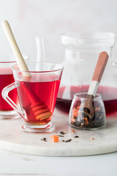Vertical close up of healthy hibiscus tea with honey ready for drinking.  - Photo, Image