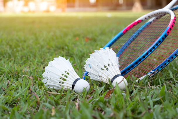 Badminton outdoor sport equipments, rackets and shuttlecocks, on grass, soft and selective focus, concept for healthy sport and recreational activity. - Foto, imagen