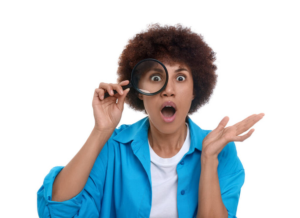 Surprised woman looking through magnifier glass on white background - Fotó, kép