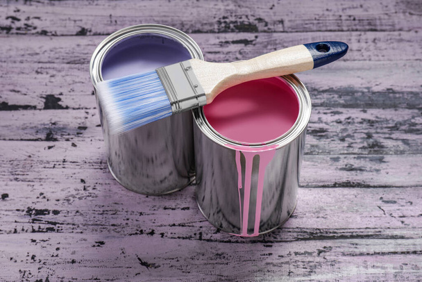 Cans of pink and lilac paints with brush on rustic wooden table - Zdjęcie, obraz