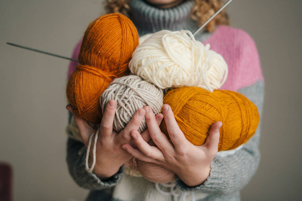 Woman holding in her hands skeins of knitting yarn. Yarn for knitting toys, childrens and adult clothes, interior items. Handmade hobby. - Foto, Imagen