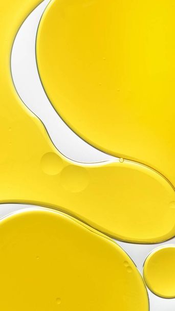 Fondo de pantalla móvil amarillo abstracto aceite burbuja textura fondo - Foto, Imagen