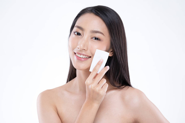 Attractive Charming Asian young woman smile and using tissue or cotton with toner cleaning make up so fresh and clean with healthy skin,isolated on white background,Beauty Cosmetics Self Care Concept - Foto, imagen