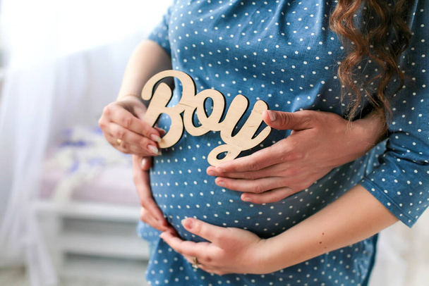 Pregnancy. Its a boy. Future parents hug and wait for the baby. High quality photo - Zdjęcie, obraz