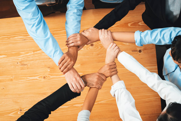 Multicultural business people holding hand together in circle. Unity teamwork in office business workplace. Diverse ethnic office worker engaged in team building. Habiliment - Zdjęcie, obraz