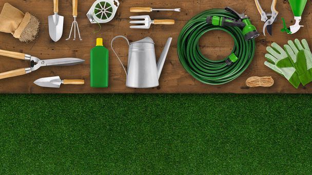 Gardening tool equipment. Top view on wooden table, lawn grass background with copy space. Online shopping commerce or advertising. Banner for florist shop or greenhouse, pruning and vegetable garden - Photo, Image