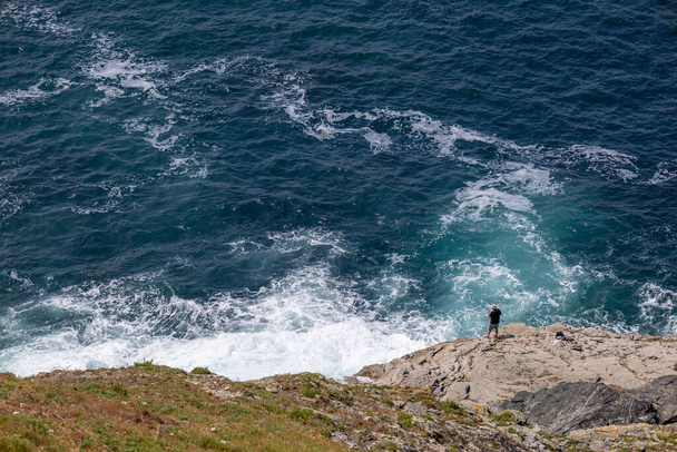 Trevose Head, Cornwall, UK - June 15.  Man fishing at Trevose Head in Cornwall on June 15, 2023. Unidentified man - Photo, Image
