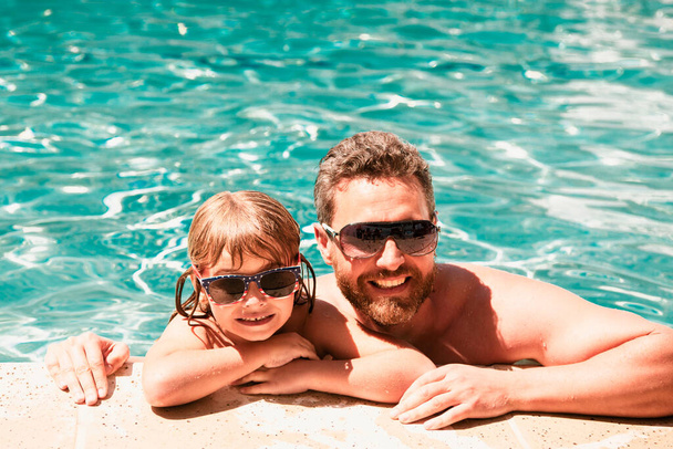 Father and son swimming in pool, summer family. Happy family at pool - Foto, Bild