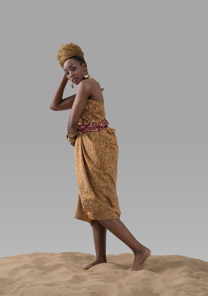 African fashion woman standing on sand - Photo, image