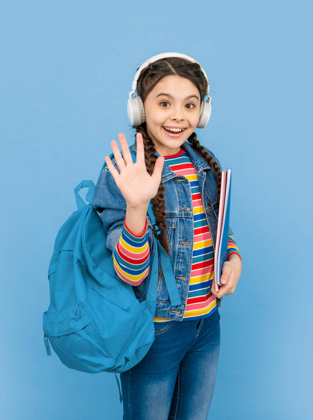 Hello school. Happy teen girl waving hand blue background, school. Back to school. September 1. Knowledge day. - Foto, afbeelding