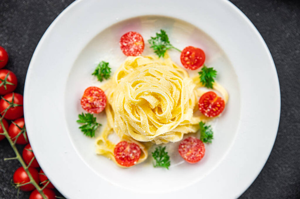 pasta tomato tagliatelle and parmesan cheese meal food snack on the table copy space food background rustic top view - Zdjęcie, obraz