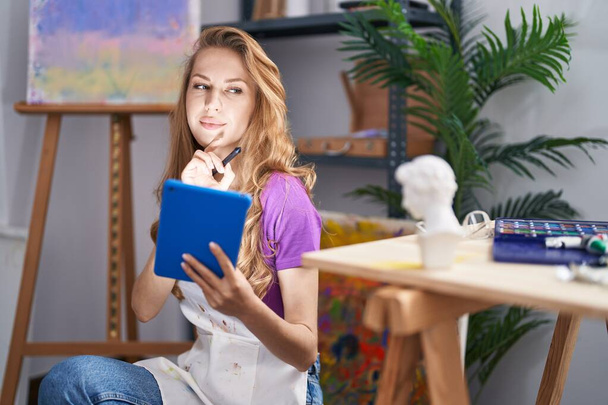 Young blonde woman artist using touchpad at art studio - Photo, Image