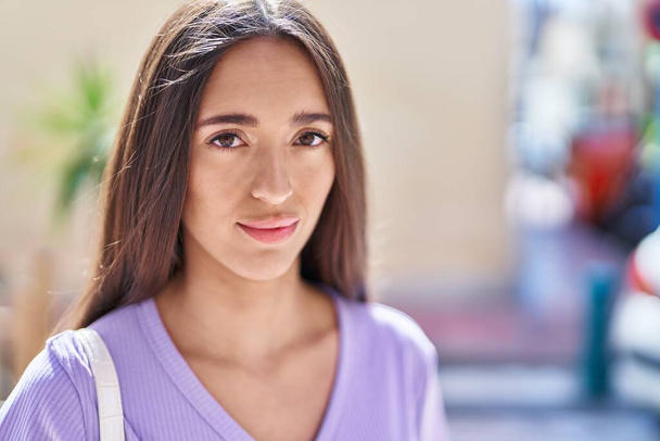 Young beautiful hispanic woman smiling confident standing at street - Photo, Image