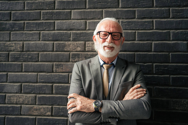 Portrait of one senior man stand on front of brick wall wear suit businessman confident happy smile - Zdjęcie, obraz