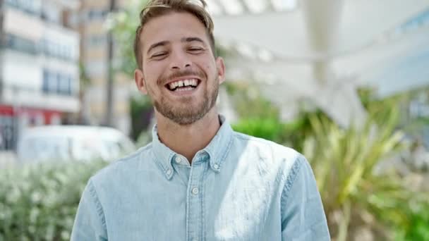 Young caucasian man laughing a lot at park - Footage, Video