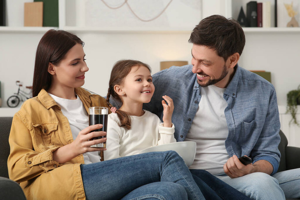 Happy family spending time together while watching TV at home - Foto, imagen