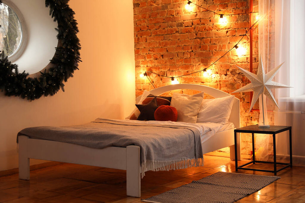 Cozy bedroom with stylish Christmas decor. Interior design - Zdjęcie, obraz