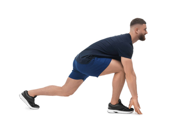 Man doing stretching on white background. Morning exercise - Foto, imagen