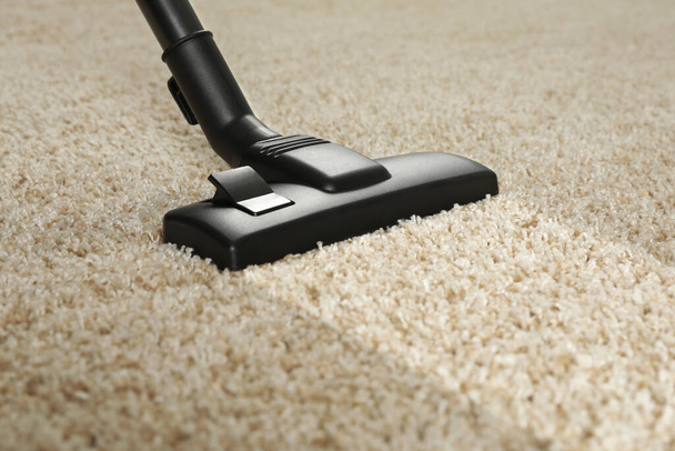 Hoovering carpet with vacuum cleaner, closeup. Clean trace on dirty surface - Фото, изображение