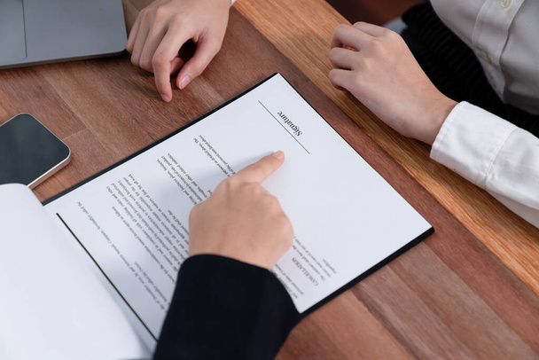Closeup business deal meeting, young businesswomen carefully reviewing terms and condition of contract agreement papers in office. Corporate lawyer give consultation on contract deal. Enthusiastic - Foto, imagen