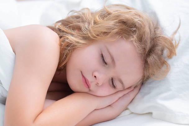 Kid enjoying sweet dreams. Little kid sleeps on bed, napping. Cute child sleeping - Fotografie, Obrázek