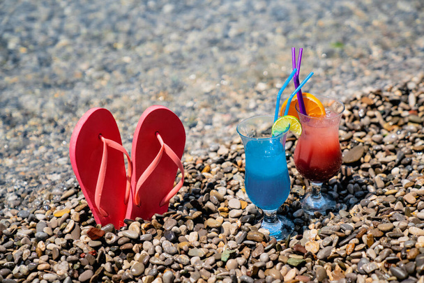 Two fresh tropical juices, cocktails on beach. Summer vacation holiday concept - 写真・画像