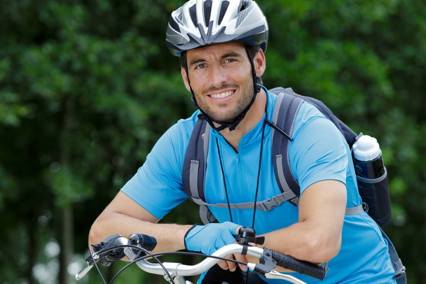 happy and cheerful biker outdoors - Photo, Image