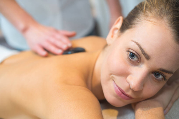 beautiful and healthy woman during a back stone therapy - Zdjęcie, obraz