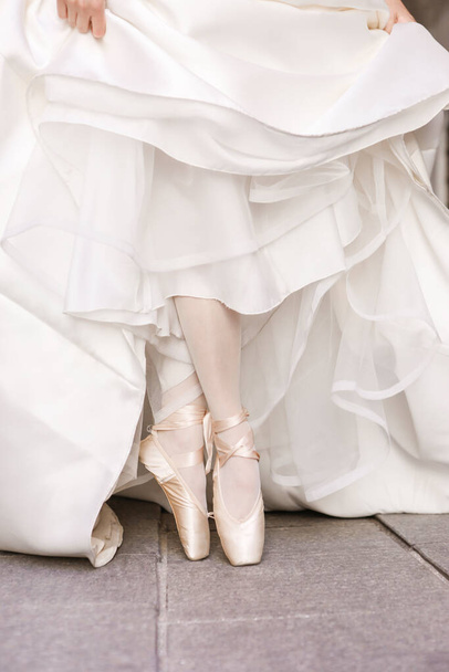 ballerina in a pointe shoes in a white dress. ballet dancer  - Photo, Image