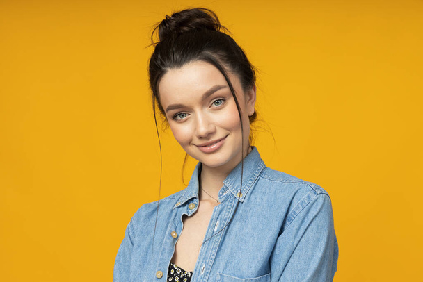 Young woman in a denim shirt, hair tied up - Photo, Image
