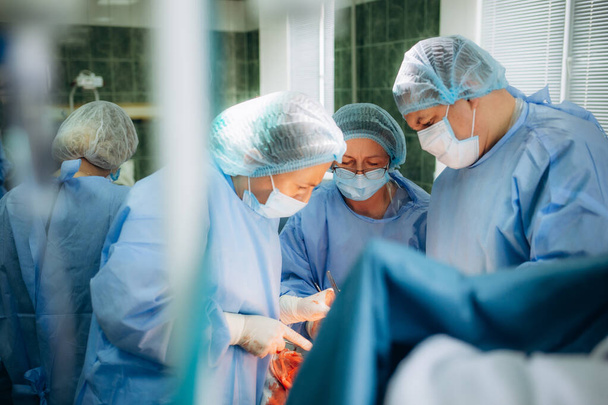 a group of doctors during cesarean births. - Photo, Image