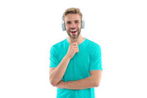 cheerful man millennial in headphones at studio. man millennial in headphones. man millennial in headphones isolated on white. man millennial in headphones on background. - Photo, Image