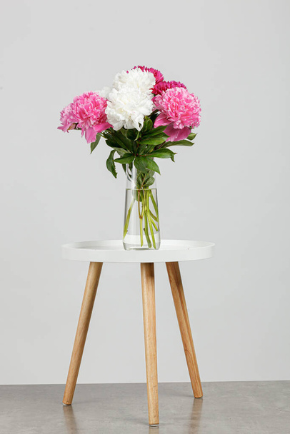 beautiful peonies in a vase on a white background close-up - Fotó, kép