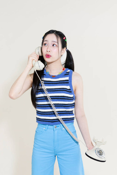 vintage y2k retro concept photo of korean asian cute woman calling against studio background - 写真・画像