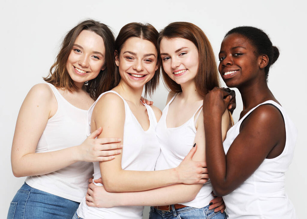 lifestyle, friendship and people concept - group of four girls friends of different nationalities - Photo, Image