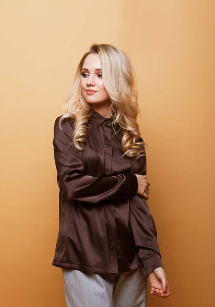 Beautiful young blond woman wearing casual over beige background - Valokuva, kuva