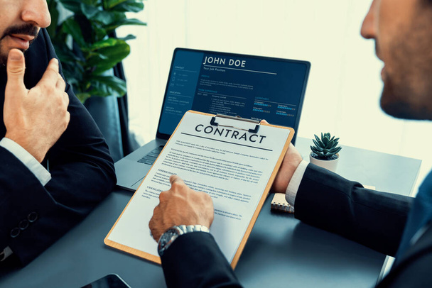 Closeup business deal meeting, businessman carefully reviewing terms and condition of contract agreement papers in office. Corporate lawyer give consultation on contract deal. Fervent - Photo, Image