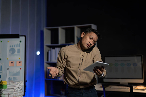 Přepracované mladé asijské kancelář zaměstnanec pracující na notebook přesčas v kanceláři v noci. - Fotografie, Obrázek
