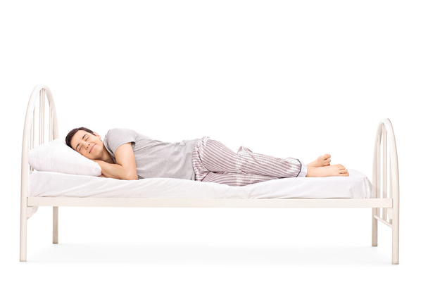 Young man sleeping in bed - Фото, изображение