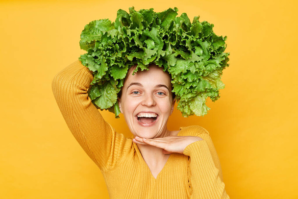 Healthy food, diet, vegetarian meal, dieting, weight loss. Smiling joyful cheerful woman with lettuce hair style with green vegetables on her head. Organic cooking. - Фото, изображение