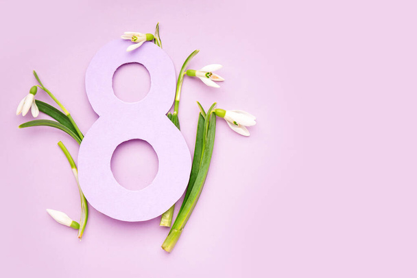 Beautiful snowdrops and number 8 on lilac background - Foto, immagini