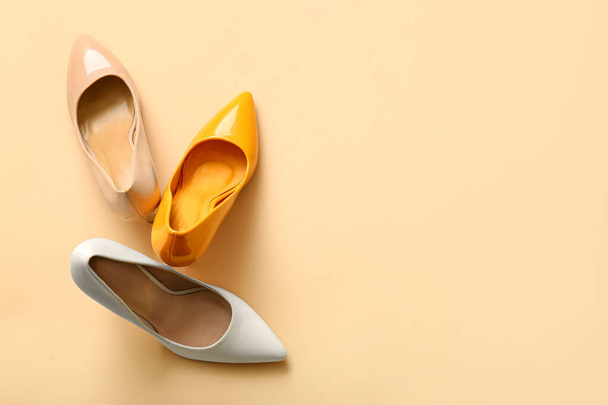Fashionable high heeled shoes on beige background - Фото, зображення