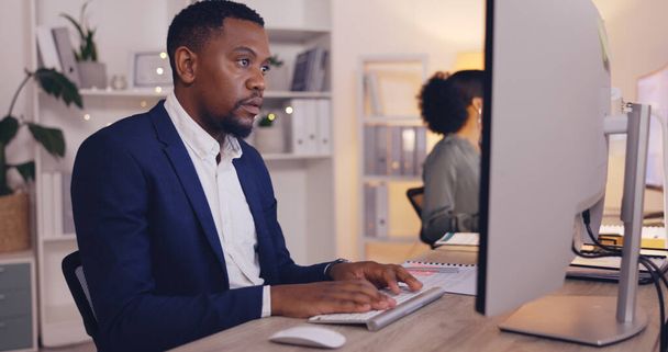 Corporate, focus and male worker at desk for writing email, website research and report, Laptop, office administration and happy black man typing finance report, online banking. - Fotoğraf, Görsel